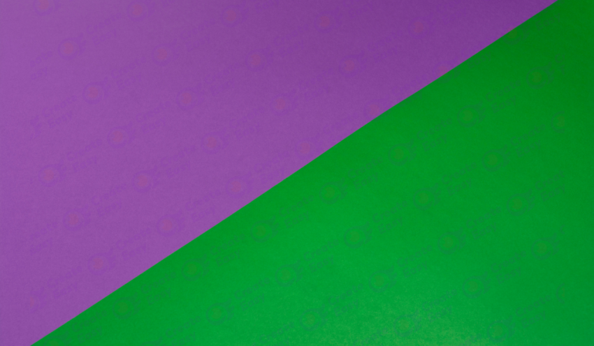 Multiple overlay patterns of a purple design on green surface color texture background